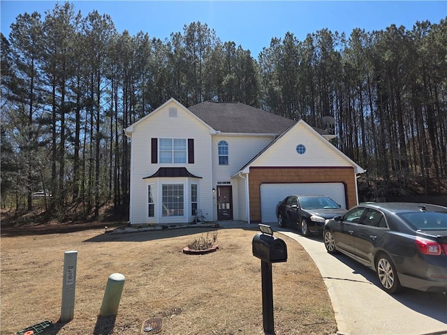 traditional home featuring a garage and concrete driveway