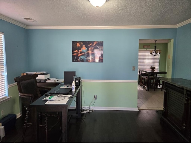 office area featuring a textured ceiling, wood finished floors, visible vents, and ornamental molding