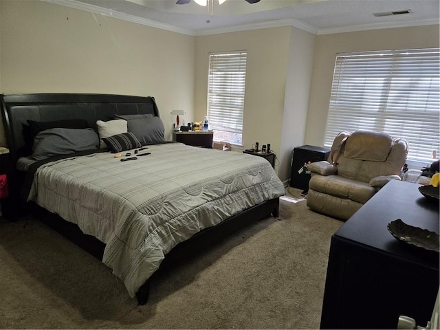 bedroom with visible vents, crown molding, ceiling fan, and carpet floors