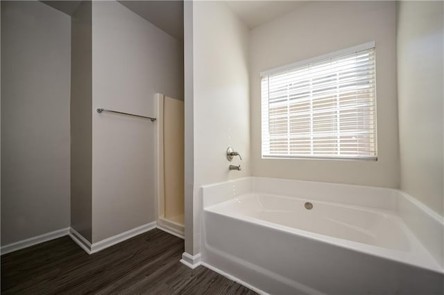 bathroom featuring a bath and hardwood / wood-style floors