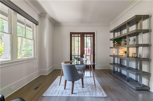 home office with plenty of natural light, visible vents, dark wood finished floors, and ornamental molding