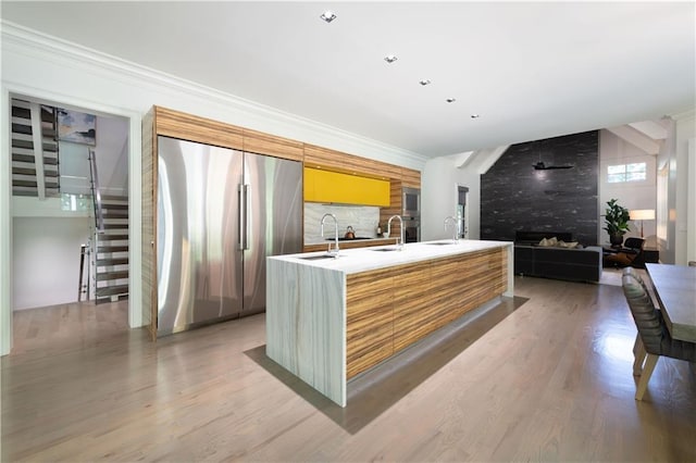 reception area featuring a large fireplace, stairway, and a sink