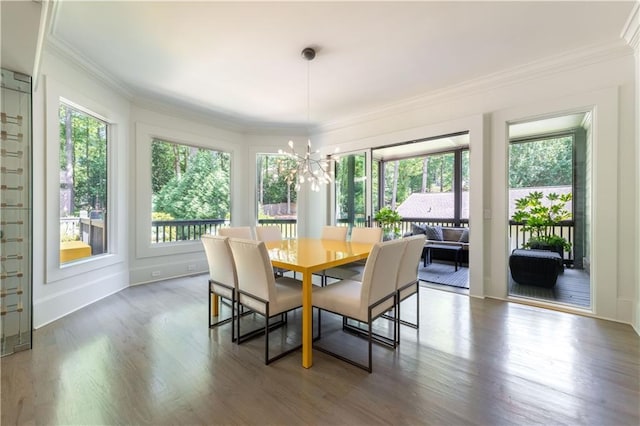 dining space featuring a chandelier, a wealth of natural light, dark wood-style flooring, and crown molding