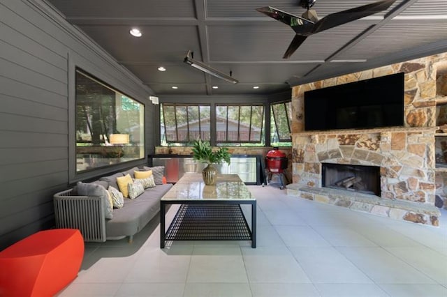 sunroom / solarium featuring an outdoor stone fireplace