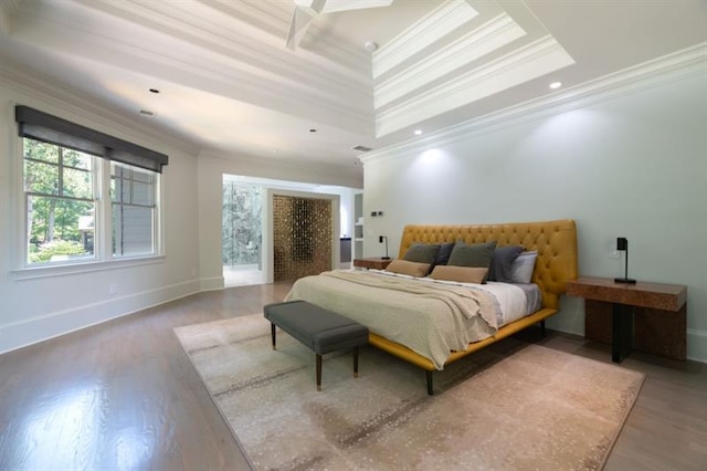 bedroom featuring recessed lighting, wood finished floors, baseboards, ornamental molding, and a raised ceiling