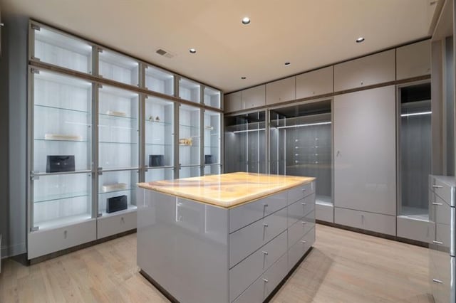 spacious closet featuring light wood-type flooring and visible vents