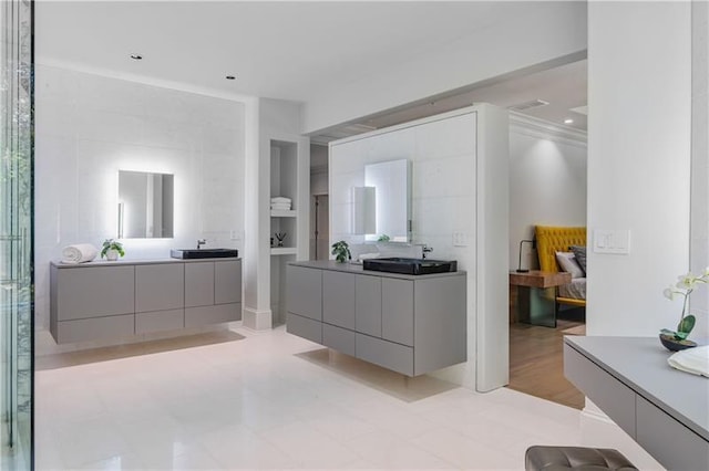 full bathroom with two vanities and a sink