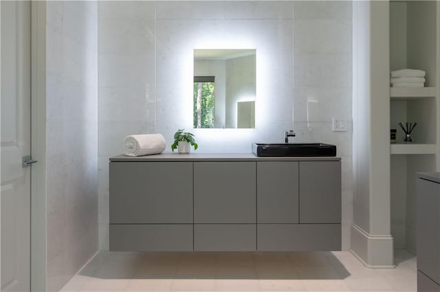 bathroom with vanity and tile walls