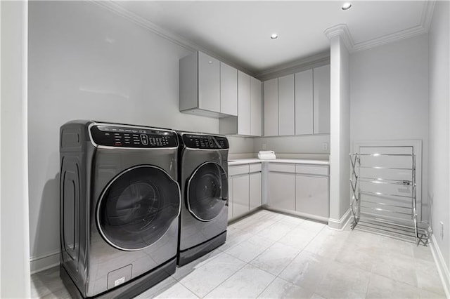 laundry area with recessed lighting, baseboards, cabinet space, washing machine and clothes dryer, and crown molding