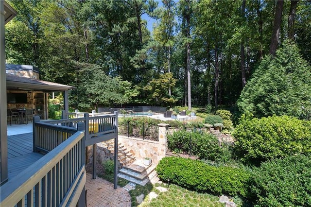 view of yard featuring a patio area, outdoor dining area, fence, and a deck