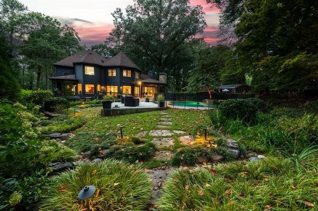 view of yard featuring a fenced in pool, a patio area, fence, and outdoor lounge area