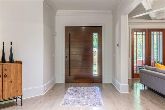 foyer entrance with baseboards, wood finished floors, beamed ceiling, crown molding, and french doors