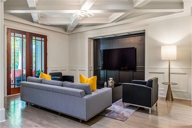 living room featuring french doors, beamed ceiling, wood finished floors, and a decorative wall