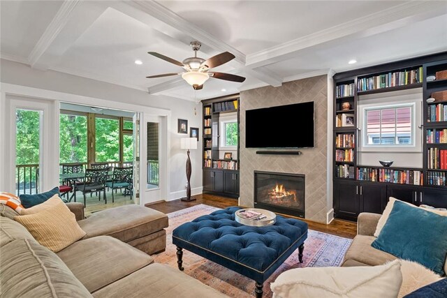 629 2nd Ave, Decatur, GA 30030 - living area with crown molding, healthy amount of natural light, a tile fireplace, wood finished floors, and baseboards