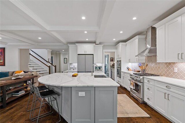 629 2nd Ave, Decatur, GA 30030 - kitchen with stainless steel appliances, wall chimney exhaust hood, a sink, open floor plan, and beamed ceiling