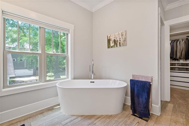 629 2nd Ave, Decatur, GA 30030 - full bathroom featuring crown molding, a freestanding tub, wood finished floors, and a spacious closet