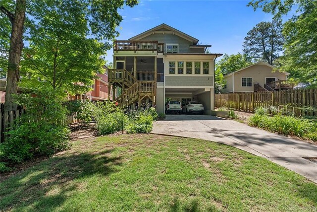 629 2nd Ave, Decatur, GA 30030 - back of property featuring concrete driveway, a carport, a sunroom, stairs, and ceiling fan