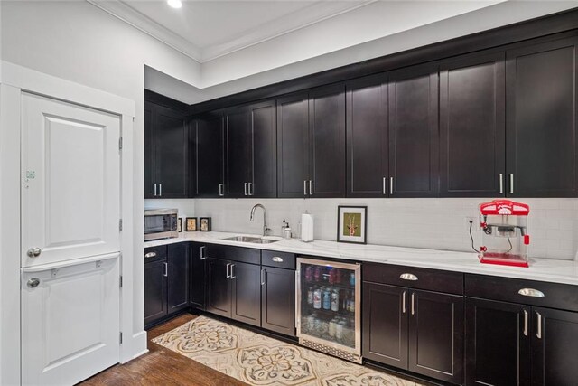 629 2nd Ave, Decatur, GA 30030 - kitchen with wine cooler, a sink, crown molding, stainless steel microwave, and tasteful backsplash
