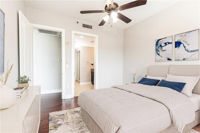 bedroom with wood finished floors, baseboards, and ceiling fan