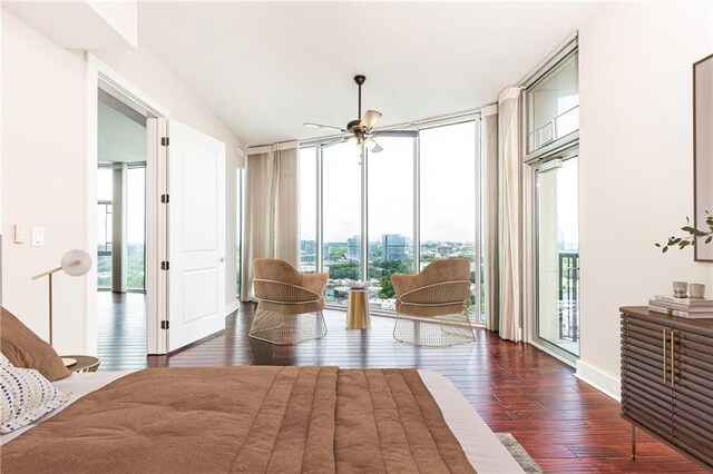 bedroom with access to exterior, floor to ceiling windows, and hardwood / wood-style floors