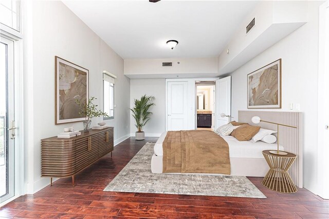 bedroom with dark wood-style floors and baseboards