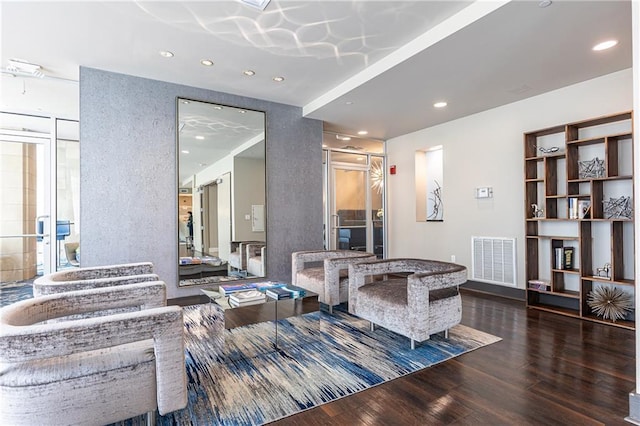living area with wood finished floors and recessed lighting