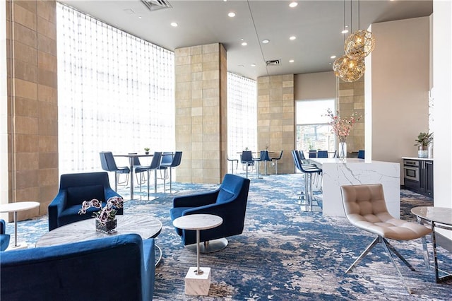 common area with recessed lighting and tile walls