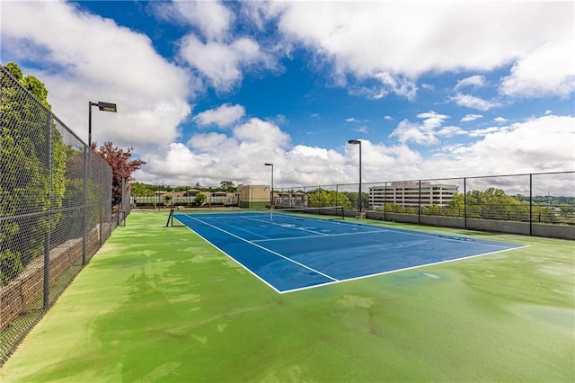 view of tennis court featuring fence