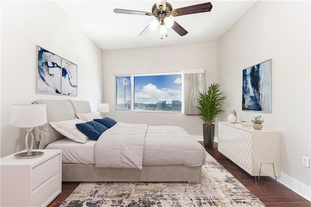 bedroom with dark wood-type flooring, baseboards, and a ceiling fan