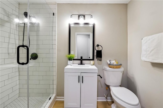 bathroom with tile patterned flooring, vanity, an enclosed shower, and toilet