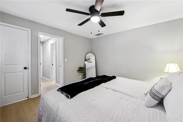 bedroom with ceiling fan and light hardwood / wood-style floors