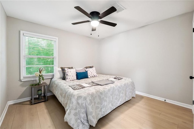 bedroom with ceiling fan and light wood-type flooring