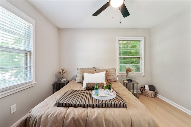 bedroom with ceiling fan and hardwood / wood-style flooring