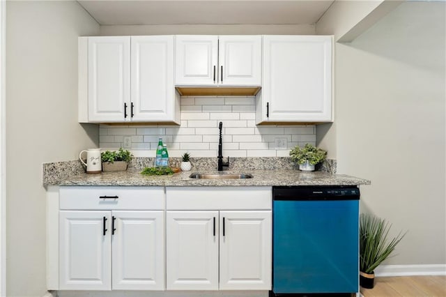 kitchen with dishwasher, decorative backsplash, white cabinetry, and sink