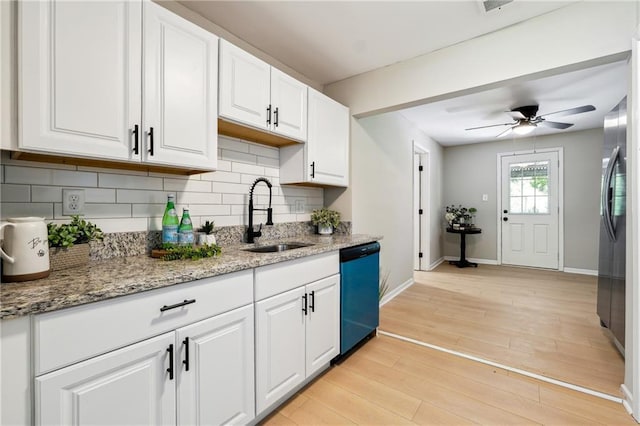 kitchen featuring light stone countertops, sink, black dishwasher, light hardwood / wood-style flooring, and white cabinets