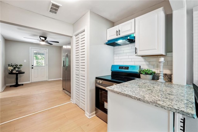 kitchen featuring light wood-type flooring, backsplash, stainless steel appliances, ceiling fan, and white cabinetry