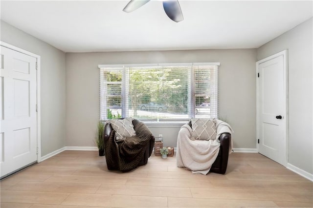 sitting room with light hardwood / wood-style floors and ceiling fan