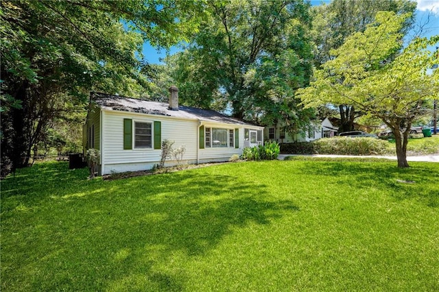 rear view of house with a yard