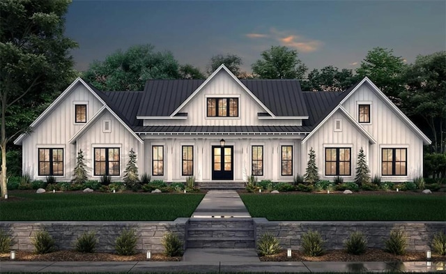 view of front of home featuring a standing seam roof, board and batten siding, and a yard