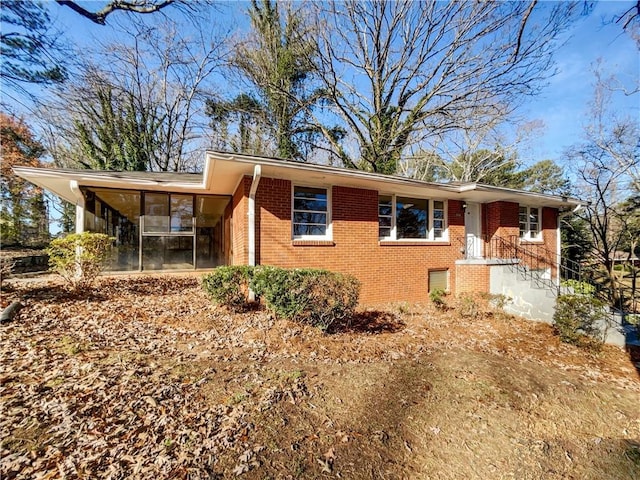 view of front of house with a sunroom