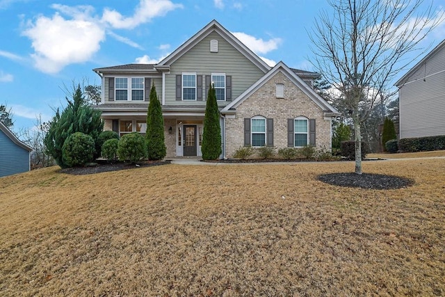 view of property featuring a front lawn