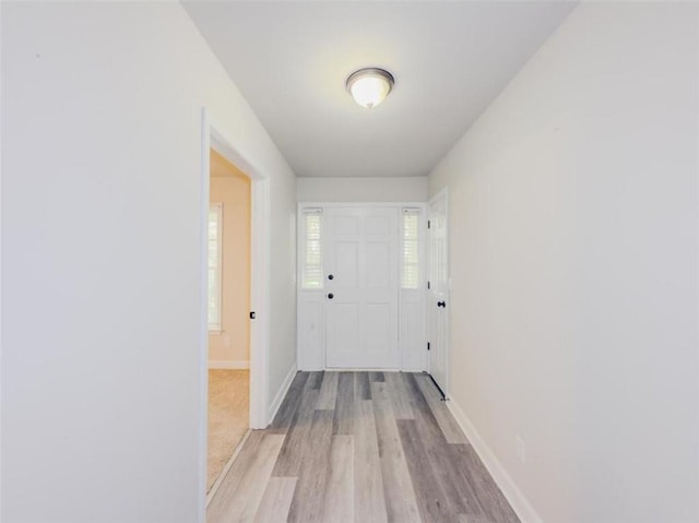 corridor with light wood-type flooring