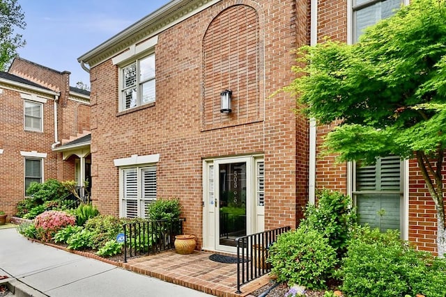 view of exterior entry with brick siding