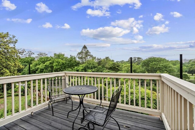 deck featuring view of scattered trees