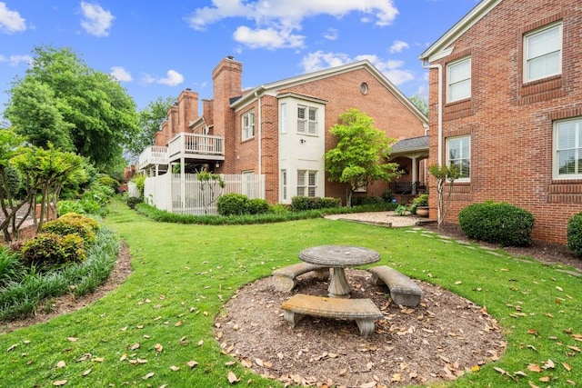 rear view of house with a chimney and brick siding