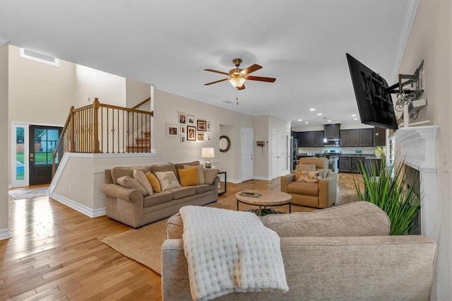 544 Pine Way, Dallas, GA 30157 - living area with a ceiling fan, light wood finished floors, stairway, baseboards, and crown molding