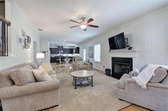 544 Pine Way, Dallas, GA 30157 - living area featuring crown molding, a ceiling fan, a fireplace, baseboards, and light wood-style floors