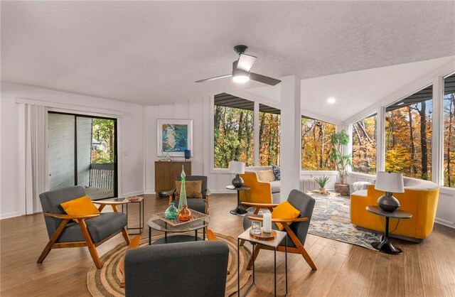 sunroom / solarium with ceiling fan, a healthy amount of sunlight, and lofted ceiling