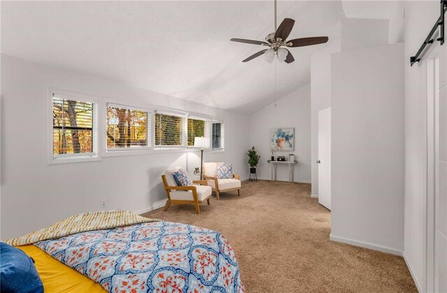 carpeted bedroom with multiple windows, a barn door, high vaulted ceiling, and ceiling fan