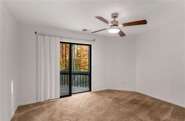 carpeted empty room featuring ceiling fan